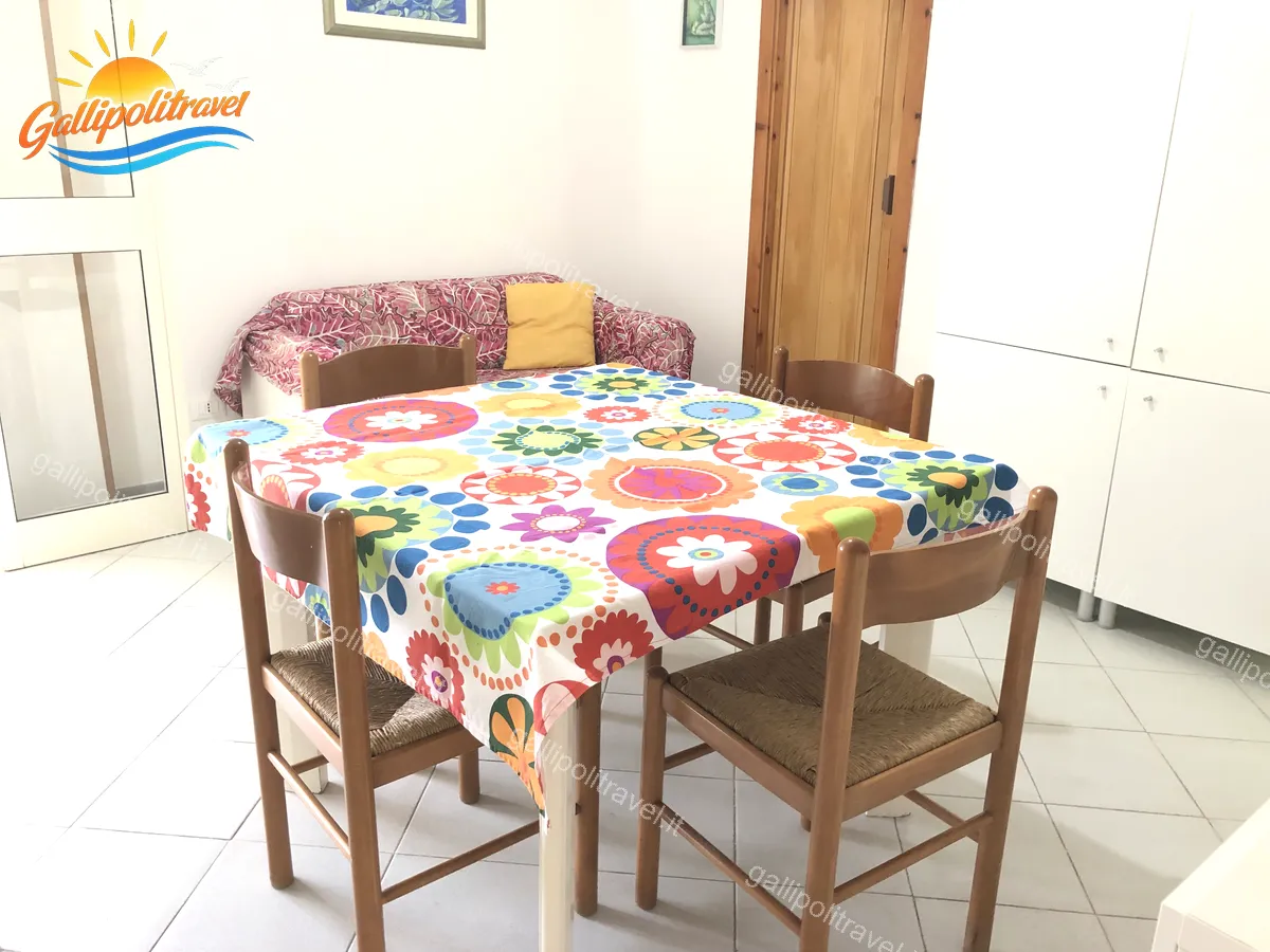 Séjour avec canapé aux motifs floraux de l'appartement trois pièces Tamerici 02, Baia Verde